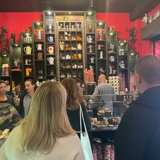 The shelving behind the counter, filled with dozens of mismatched coffee pots and jugs